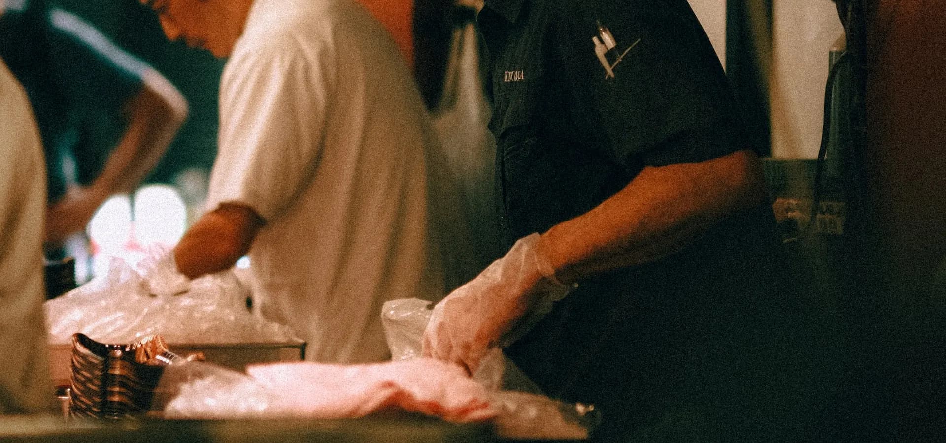Restaurant kitchen staff preparing food during service