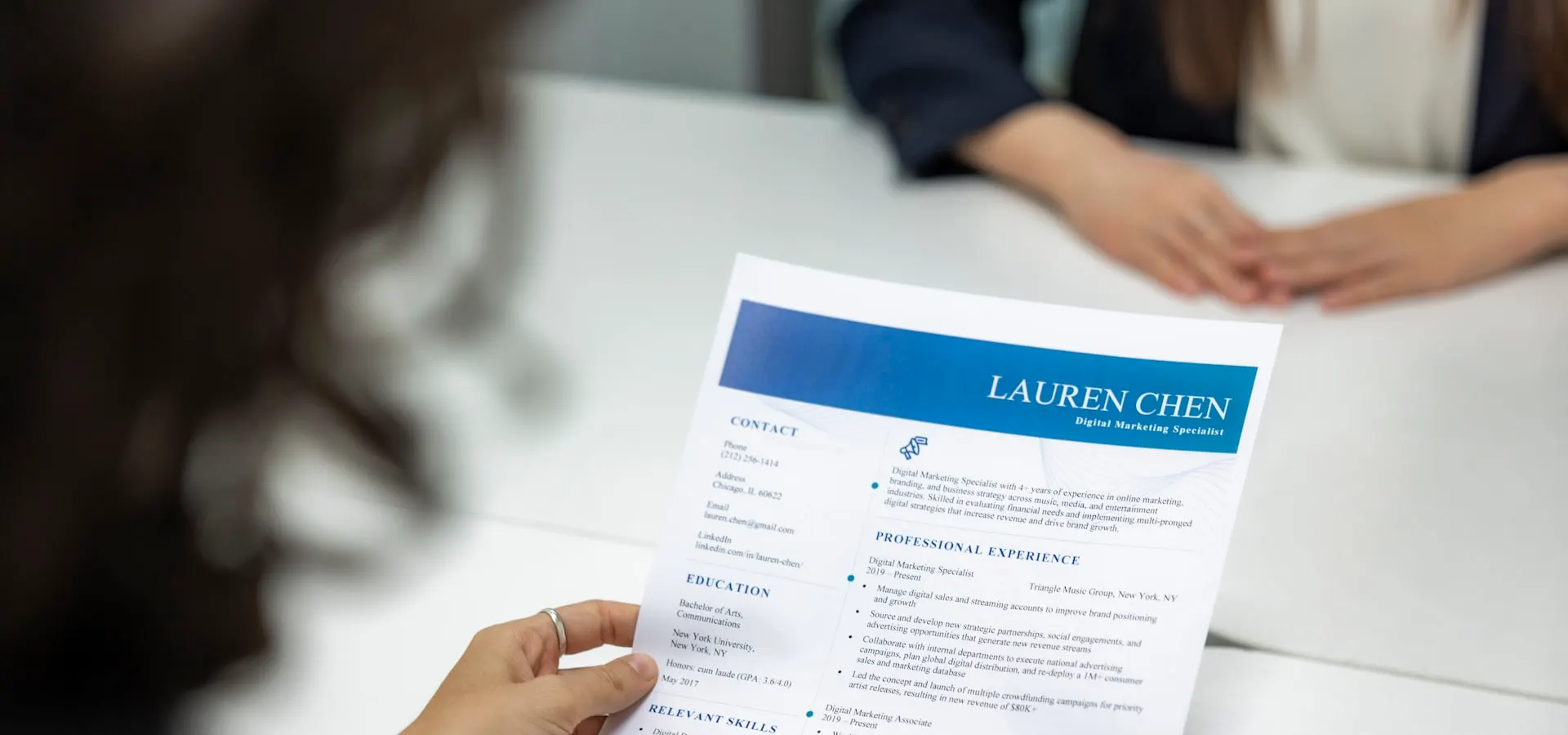 An HR professional reviewing a candidate resume