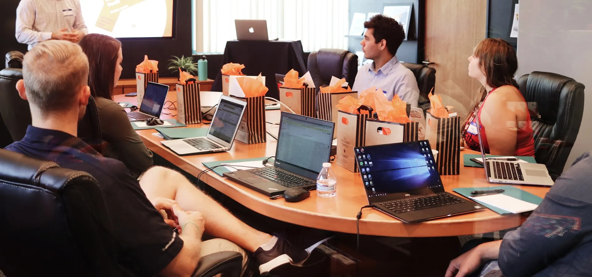A sales team reviewing a pitch presentation in a meeting room