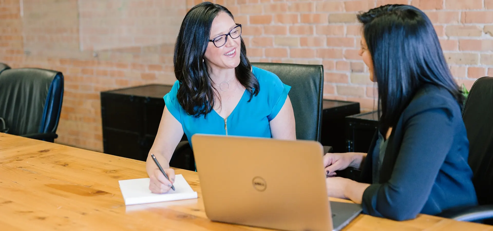 A financial advisor meeting with a client over a laptop