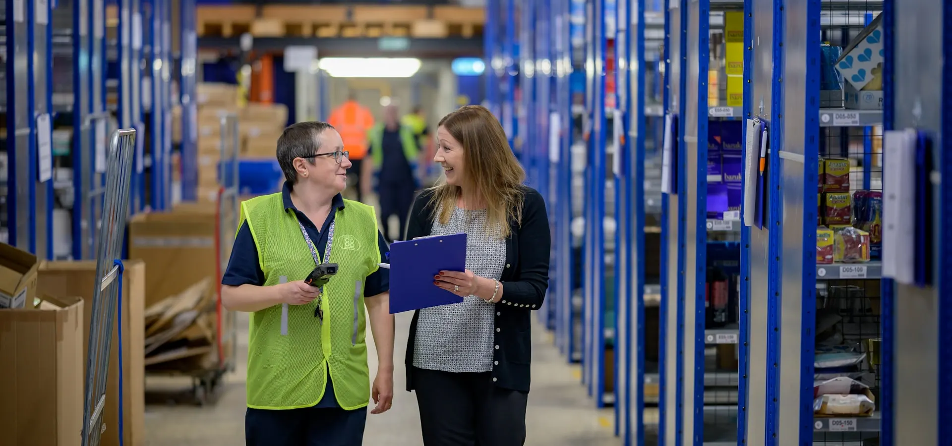 Warehouse staff reviewing inventory in a supply chain facility