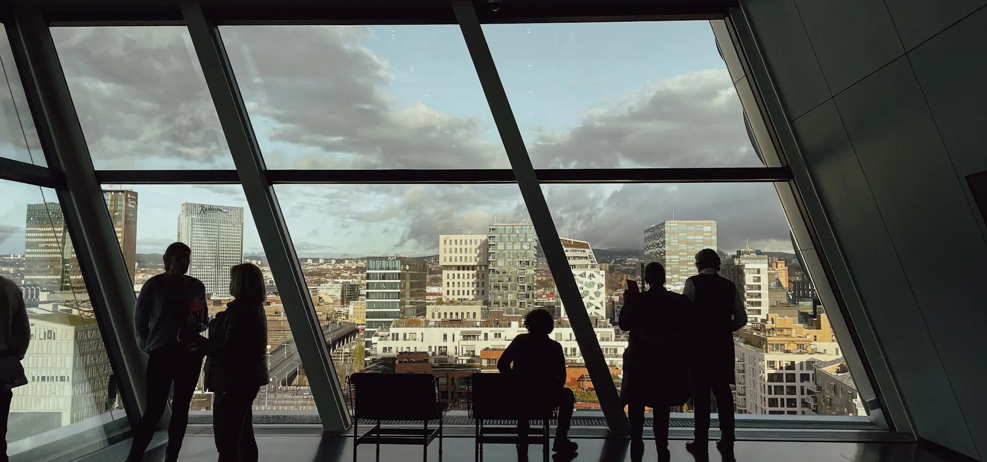 People looking out over a European city skyline from a modern office building