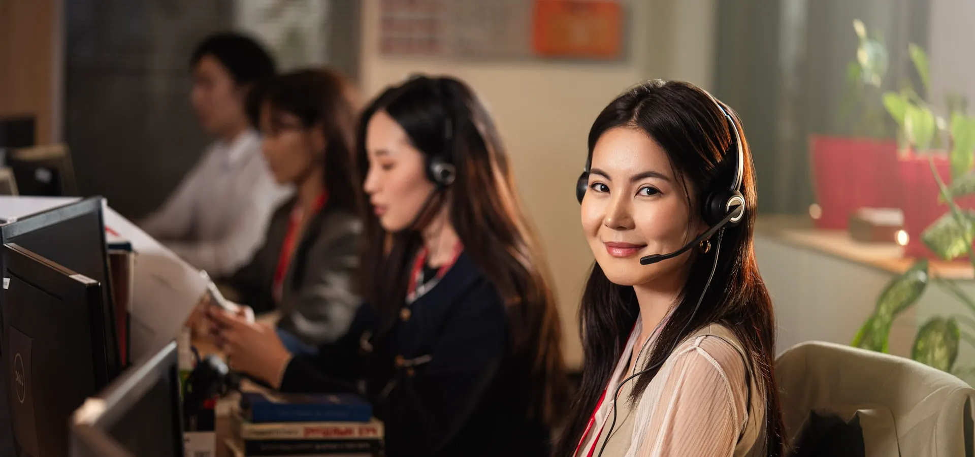 A smiling customer support agent wearing a headset